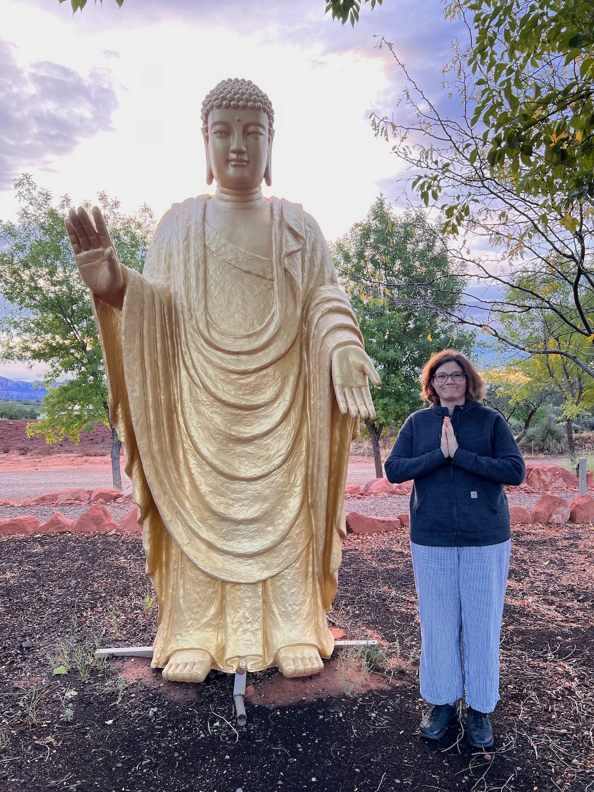 Jess standing next to large Buddha stature